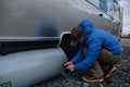 AIRSKIRTS Inflatable RV Skirt Valve Close-Up - Person Deflating Tube at Airstream Entry Steps | United RV Parts