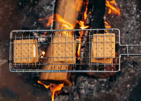 3 S'Mores Cooking in Chrome Campfire Grill Basket Over Open Flame - In Use | United RV Parts