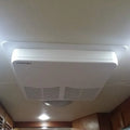 White Coleman RV Air Conditioner Silencer CA200 with CT204 Trim Ring Installed on RV Ceiling | United RV Parts