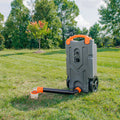 Grey Camco Rhino Tank In Use - Outdoor Field Setup with Hose | United RV Parts