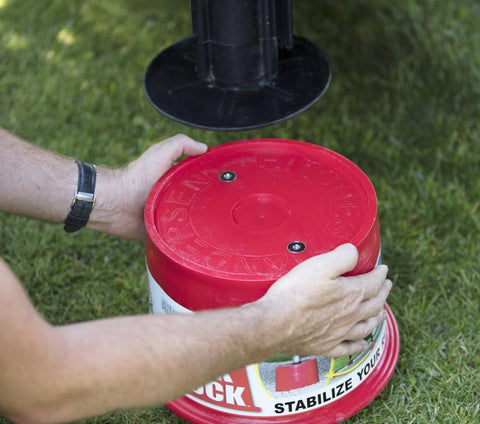 Hands Holding Red Andersen Jack Block - Size Demonstration | United RV Parts