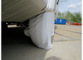 White ADCO RV Tire Cover on Motorhome Wheel - Outdoor Lifestyle Shot | United RV Parts