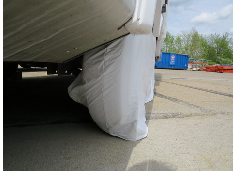 White ADCO RV Tire Cover on Motorhome Wheel - Outdoor Lifestyle Shot | United RV Parts