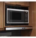 GE RV Microwave GCBK09N1WSS with Black Trim Kit in RV Kitchen Cabinet - Angled Side View | United RV Parts